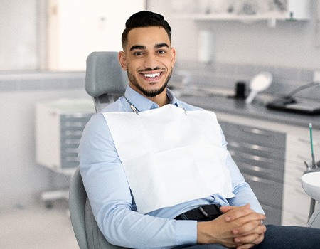 Patient smiling while sitting in treatment chair