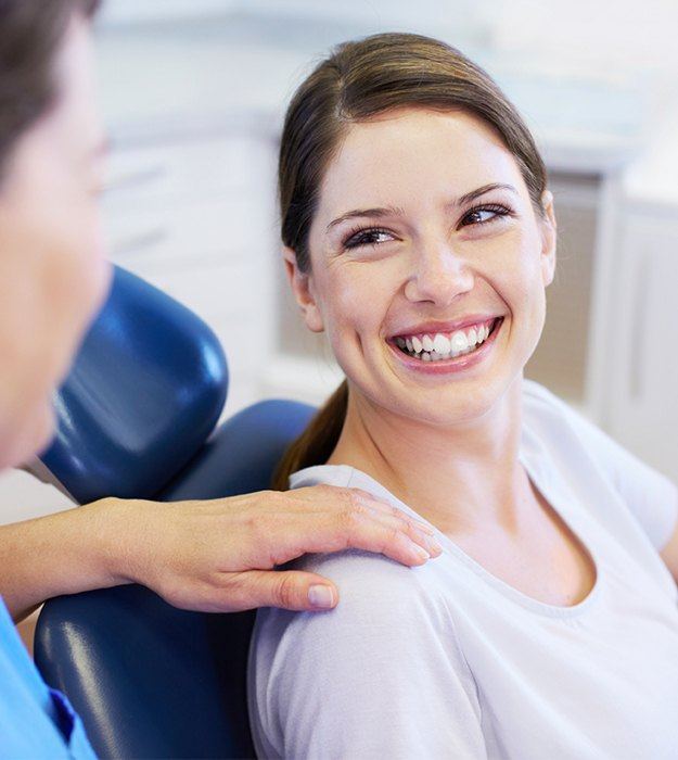 Woman in dental chair smiling