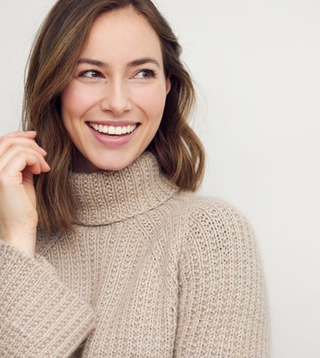 Woman smiling brightly on white background