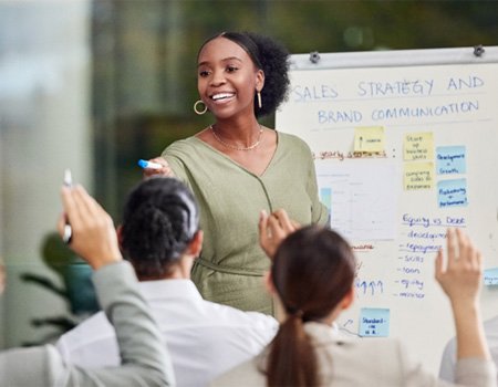 Woman smiling while giving presentation at work