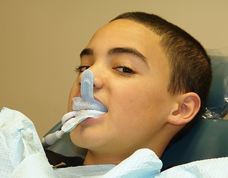 Young boy receiving fluoride treatment