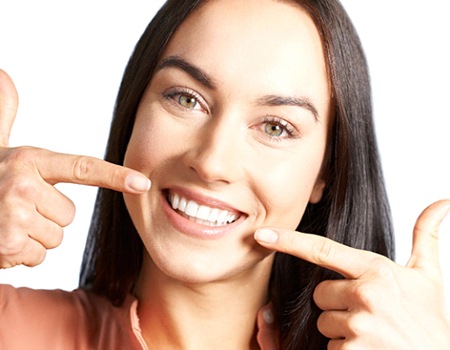 woman pointing to her teeth