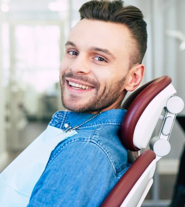 a patient smiling after visiting his dentist