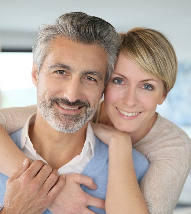 Older man and woman smiling together