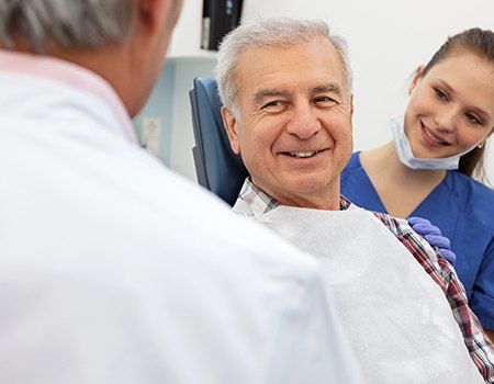 Older man smiling in dental chair