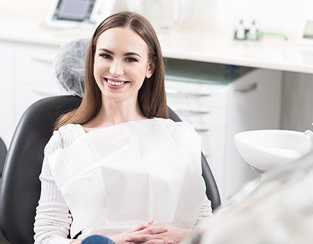 Woman in dental chair smiling