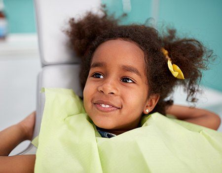 Smiling little girl in dental chair