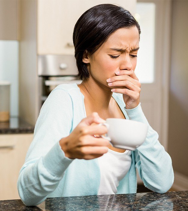 Woman in pain covering mouth