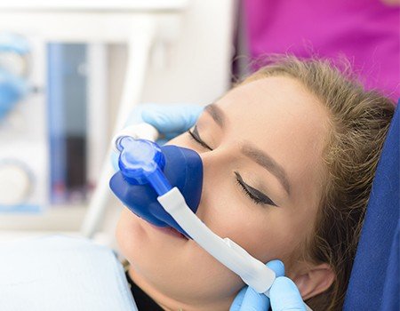 Woman with nitrous oxide nasal mask