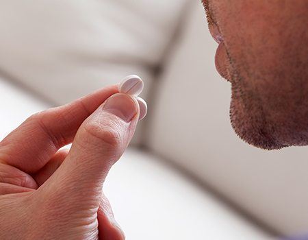 Man taking sedative pill