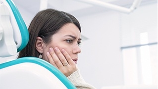 Woman in pain holding jaw