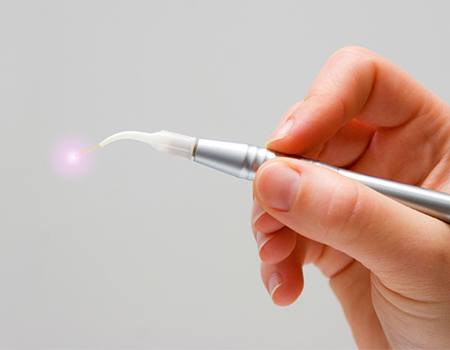 Hand holding a soft tissue laser