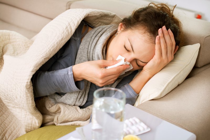 woman blowing her nose cold symptoms