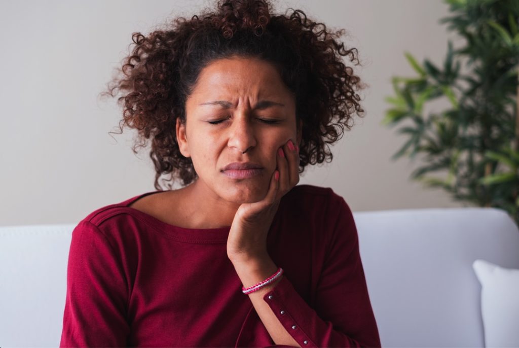 Woman needing to see emergency dentist