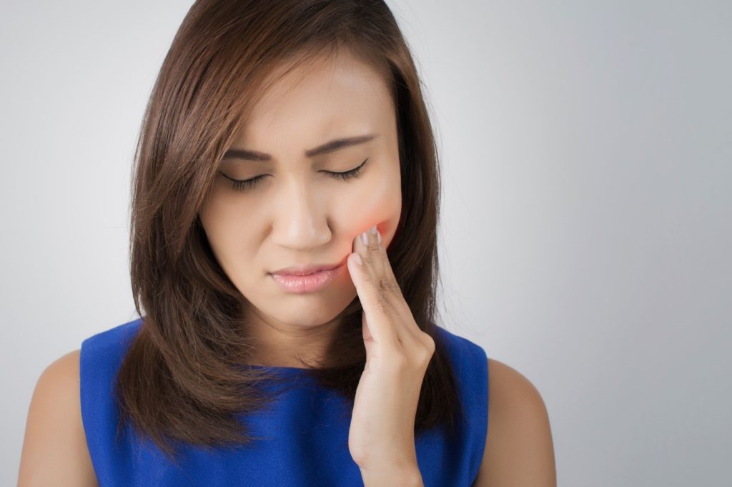 Woman experiencing tooth sensitivity