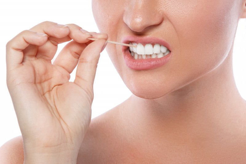 Woman using a toothpick