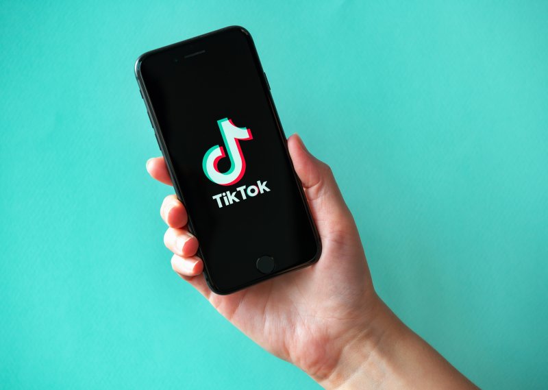 hand holding up phone with TikTok app