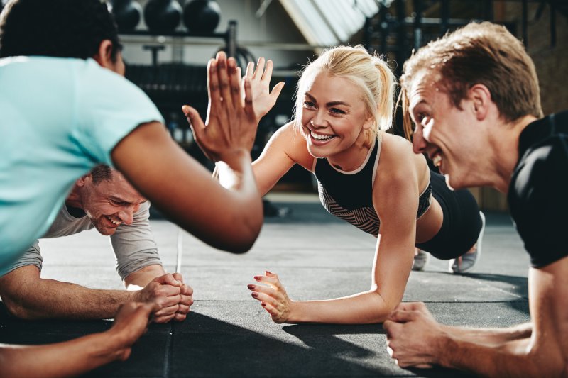 friends high fiving while exercising