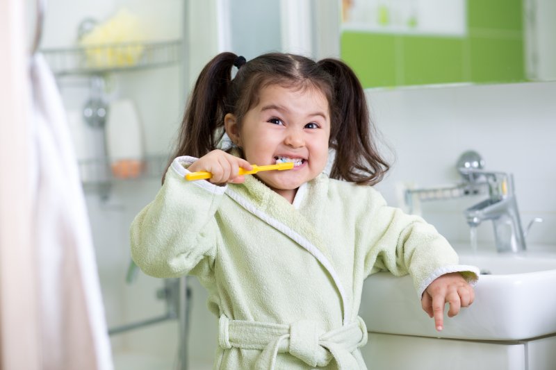 girl brushing her teeth during cold and flu season in Spring House 