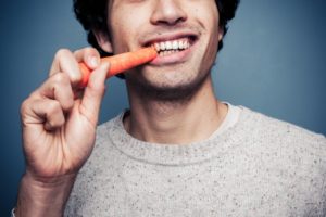 man eating carrot 