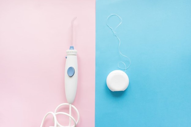 Waterpik and dental floss side-by-side comparison.