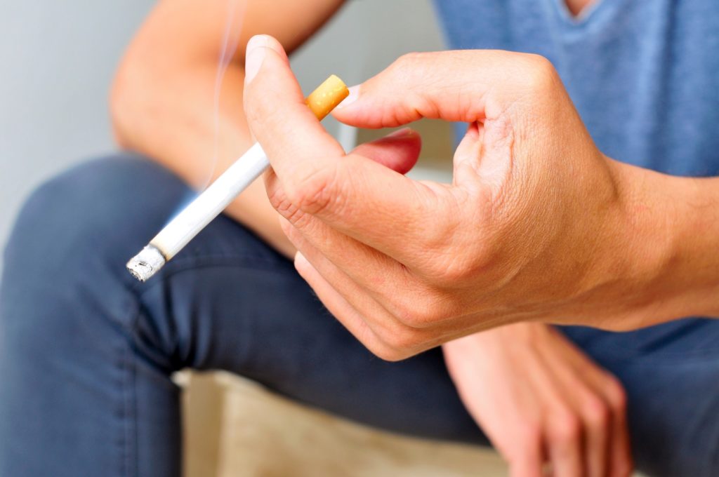 Closeup of man holding cigarette