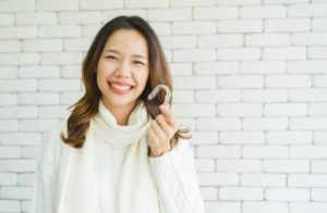 a woman smiling with Invisalign during the holidays