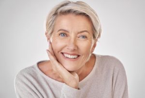 an older adult smiling after Invisalign