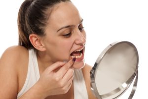 a patient inspecting their teeth