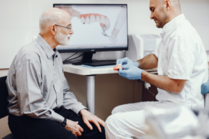 a patient visiting their dentist to receive dentures 