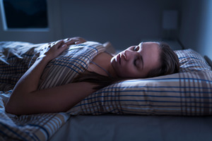 Woman with sleep apnea snoring in bed